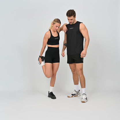 Two people wearing black athletic wear on a light gray background