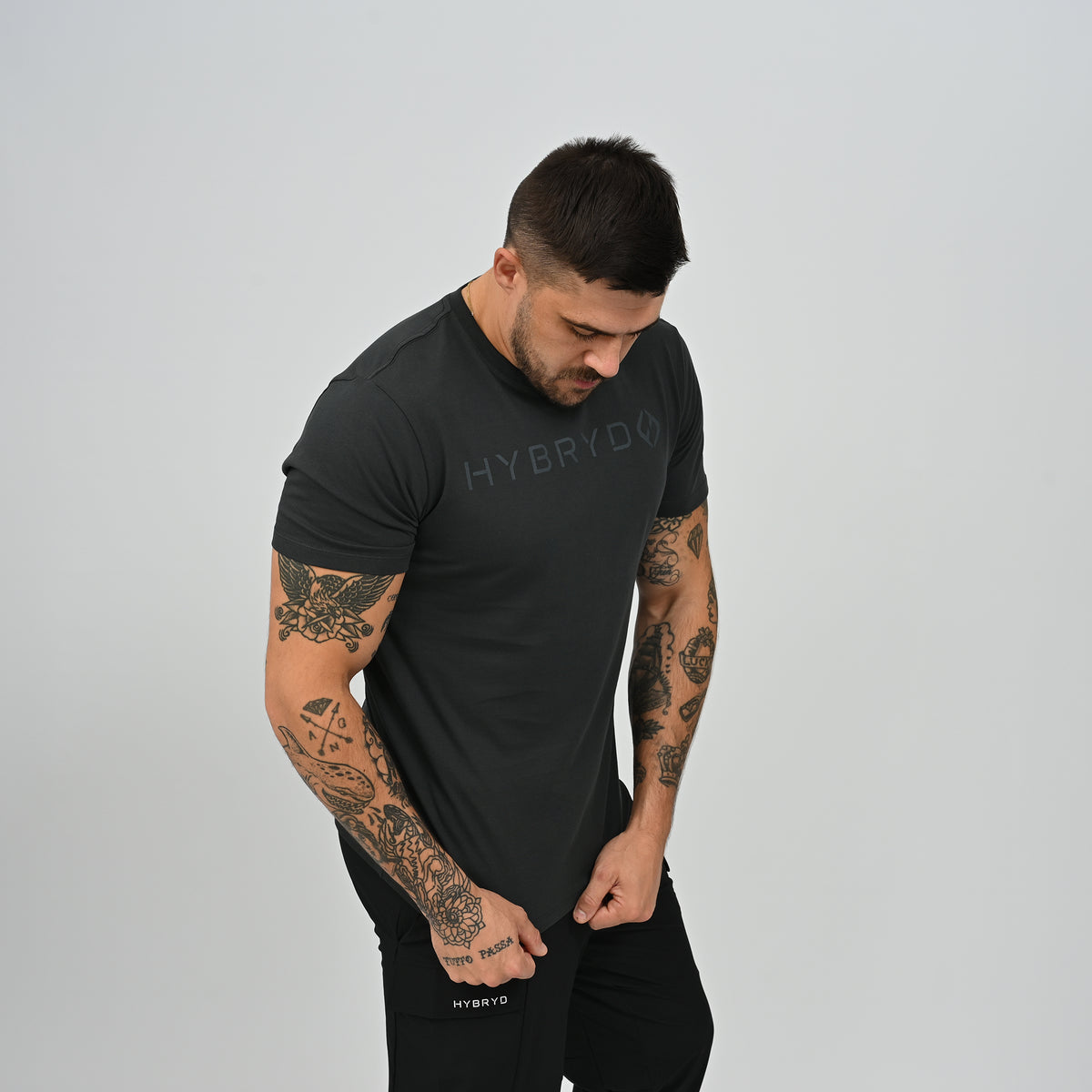 Side profile view of male athlete in black Hybryd Delta Core training t-shirt   