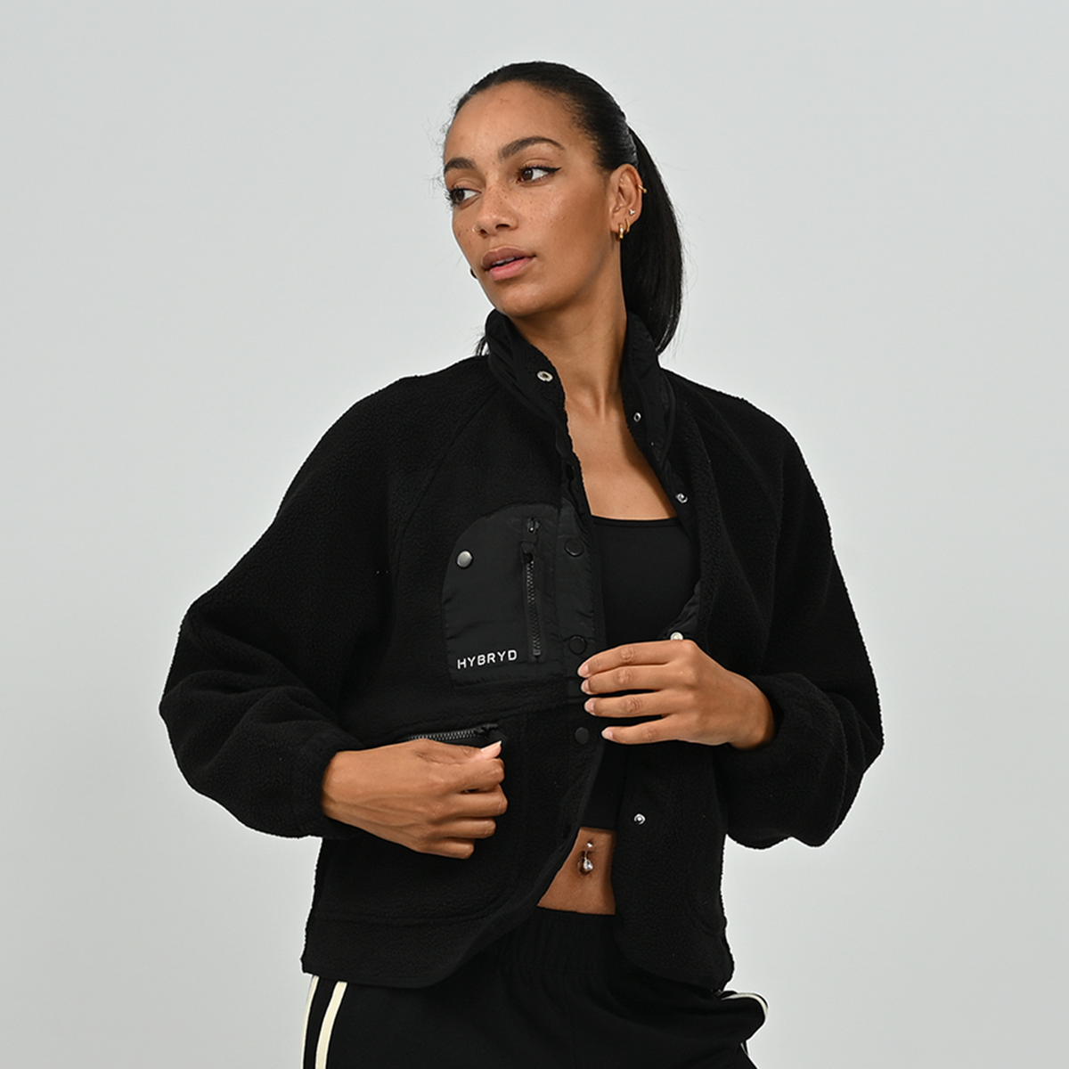 Front view of female model posing in women's black Hybryd Huntsville cozy teddy fleece jacket   