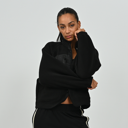 Front standing view of model in women's black Hybryd Huntsville button-up teddy bear fleece jacket