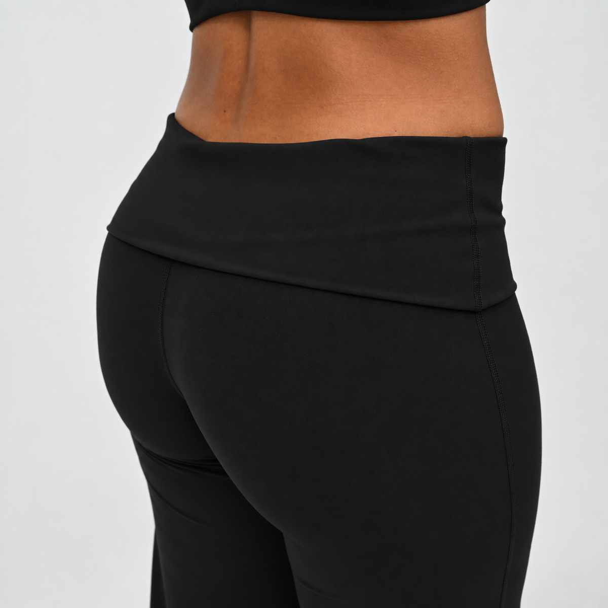 Close-up of black Gracie wide leg leggings with soft fold-over waistband