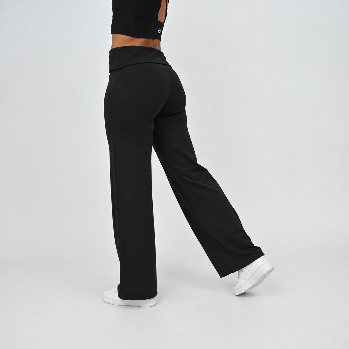 Women’s black wide leg leggings showing side fit and fold-over waistband