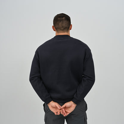 Back view of model wearing the Hybryd Jasper crew neck sweatshirt in navy blue.