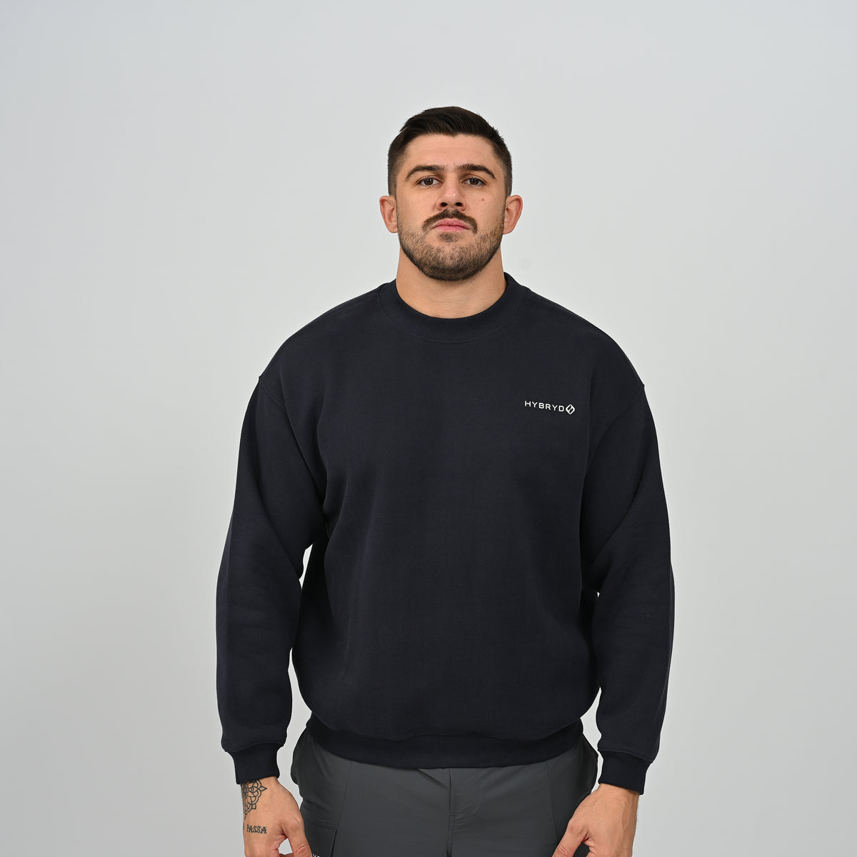Front view of model wearing the Jasper relaxed fit crew neck fleece sweatshirt in navy.