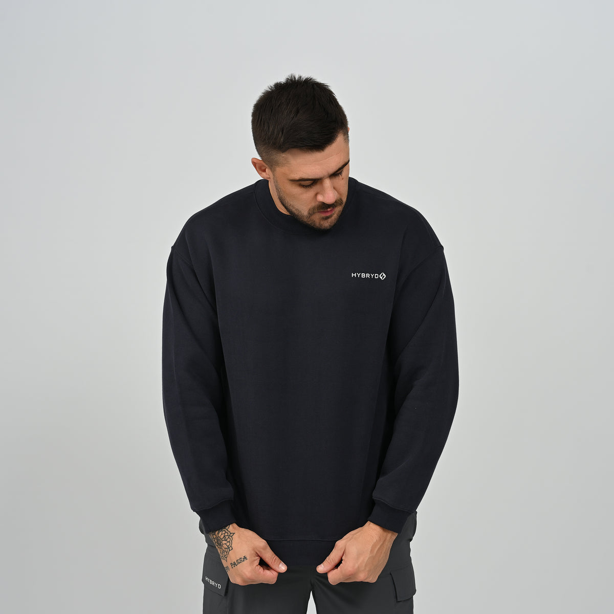 Man wearing the Hybryd Jasper relaxed fit fleece-lined crew neck sweatshirt in navy blue, front view
