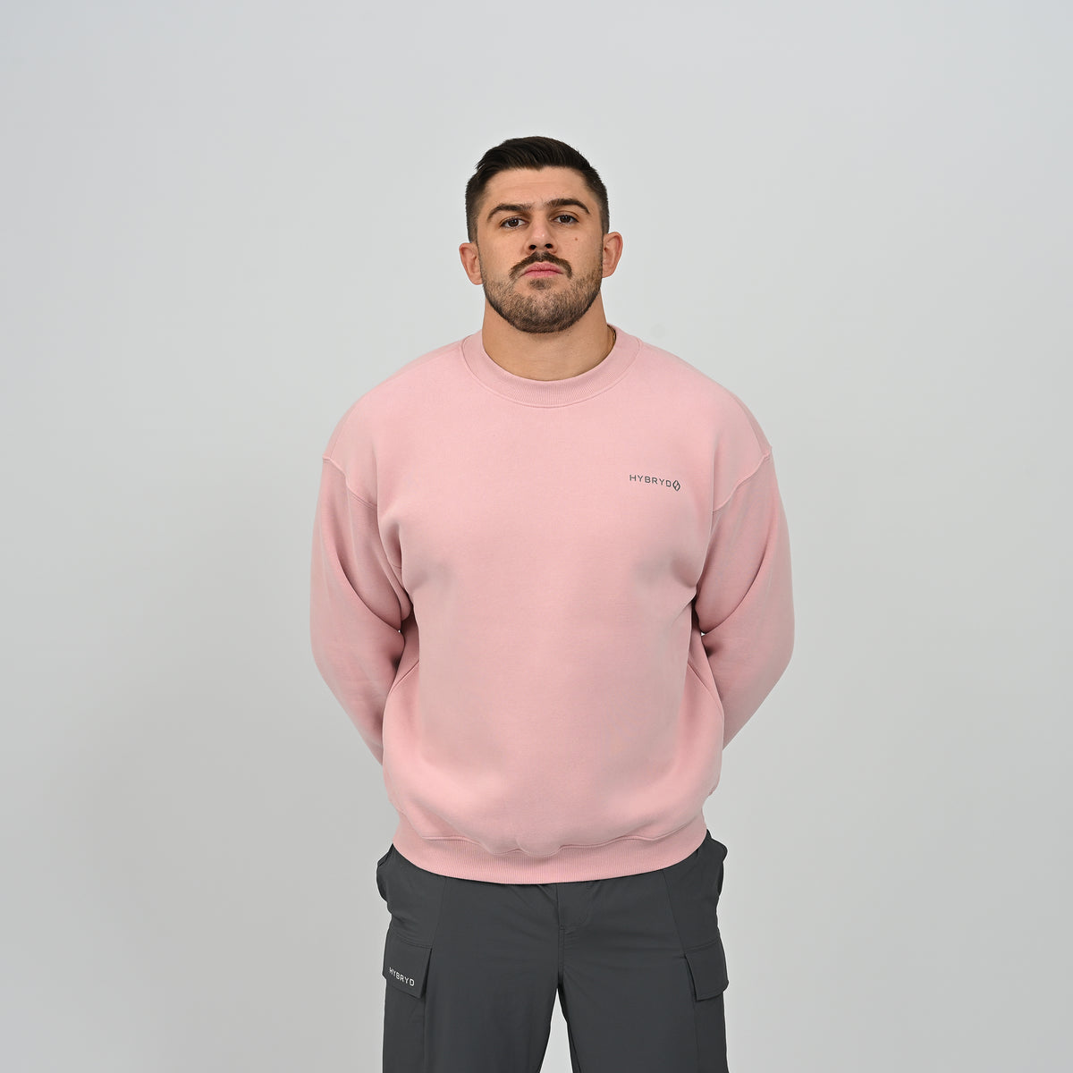 Full front view of the men's Hybryd Jasper fleece-lined crew neck sweater in pink.
