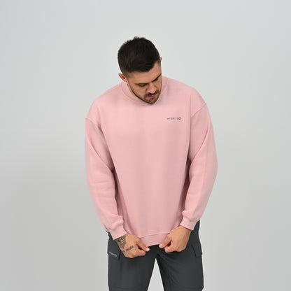 Front view of model in the pink Jasper crew neck sweatshirt standing casually.