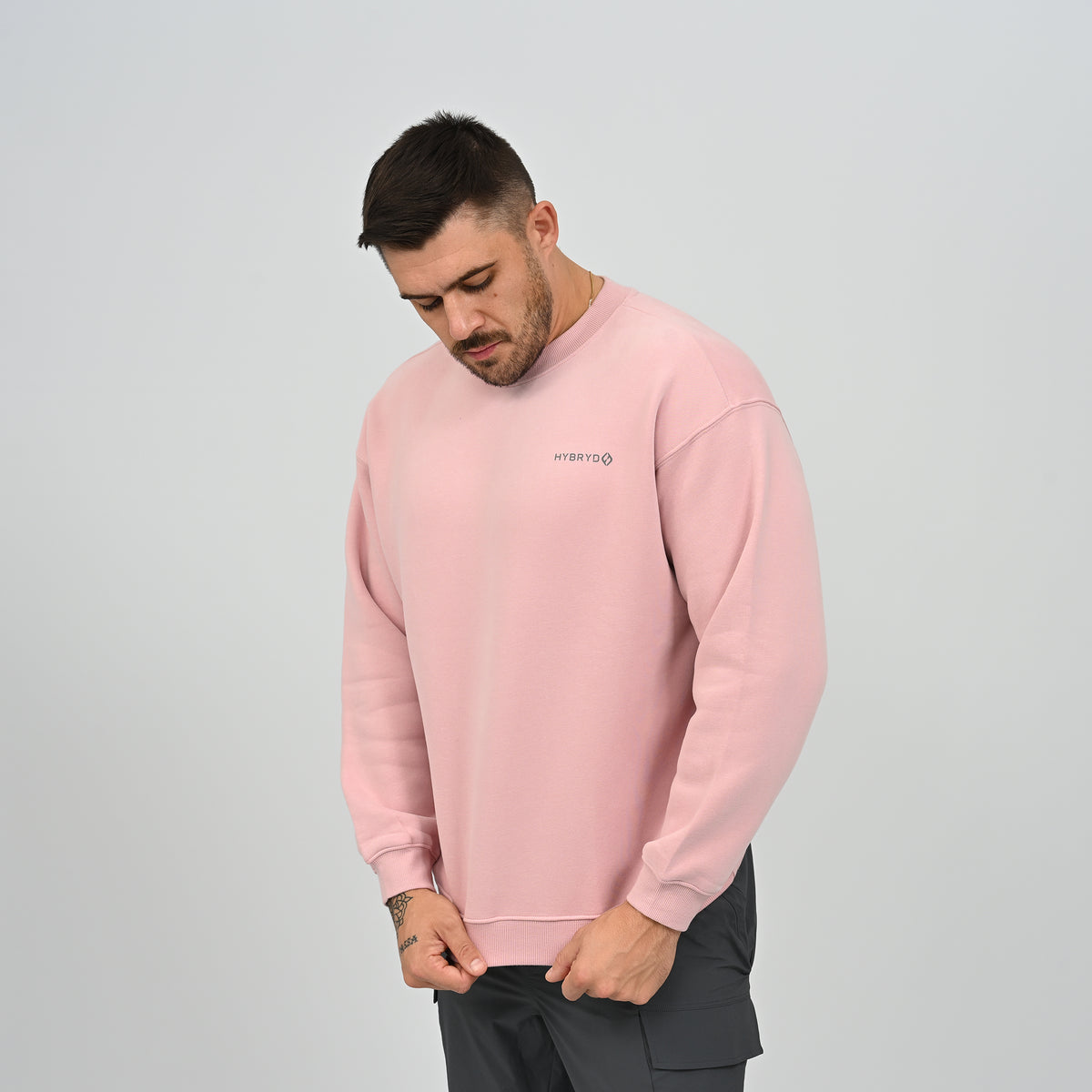 Side profile of model wearing the Jasper relaxed fit fleece-lined crew neck sweatshirt in pink.