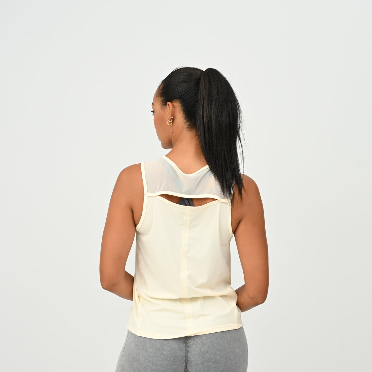Breathable mesh shoulder detail on the HYBRYD Molly women’s training vest in Butter