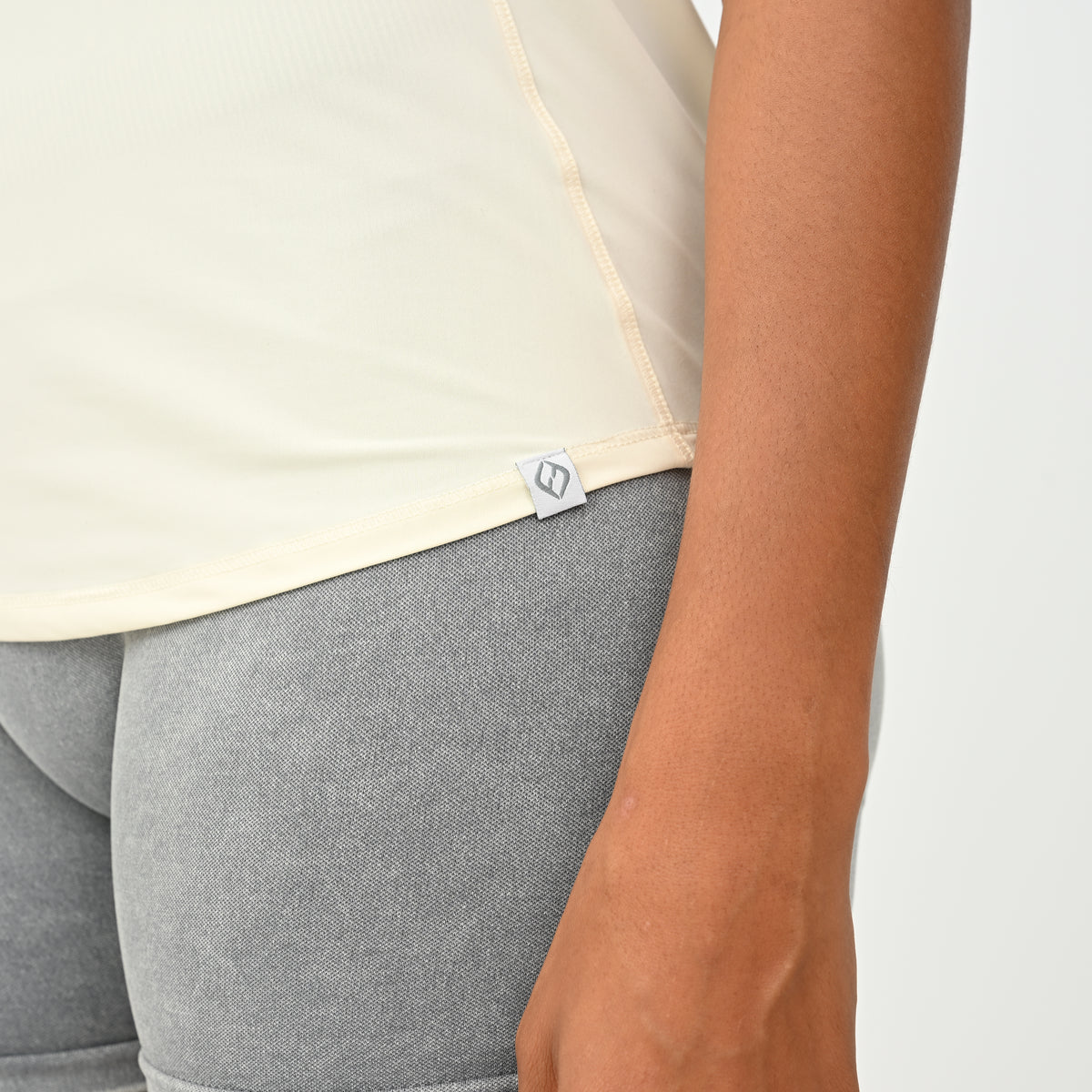 Close-up of the HYBRYD Molly women’s gym vest in Butter showing lightweight construction