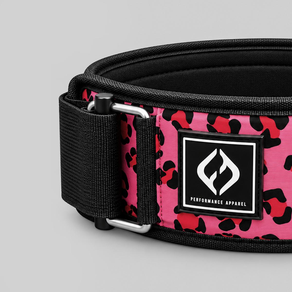 Close-up of HYBRYD pink leopard weightlifting belt featuring black woven Velcro strap, metal buckle, branded patch and reinforced stitching.