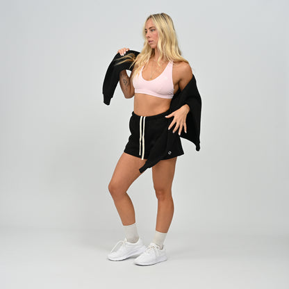 Full body front view of model wearing the black Hybryd Scottsdale matching crewneck sweatshirt and shorts set