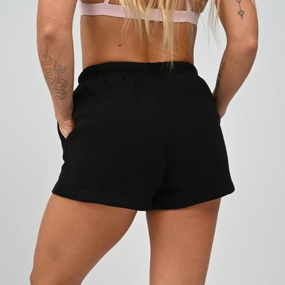 Back view of model wearing the black Hybryd Scottsdale lounge sweat shorts matching set piece