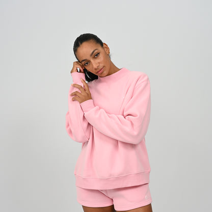 Front view of model wearing the full pink Hybryd Scottsdale matching crewneck sweatshirt and shorts set