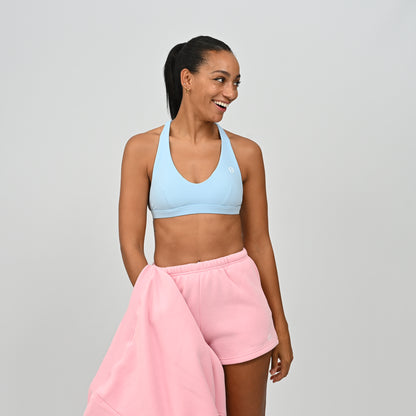 Model wearing pink Hybryd Scottsdale matching sweat shorts paired with a crop top