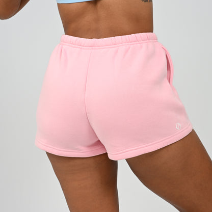 Side view of model wearing the pink Hybryd Scottsdale matching lounge sweat shorts   