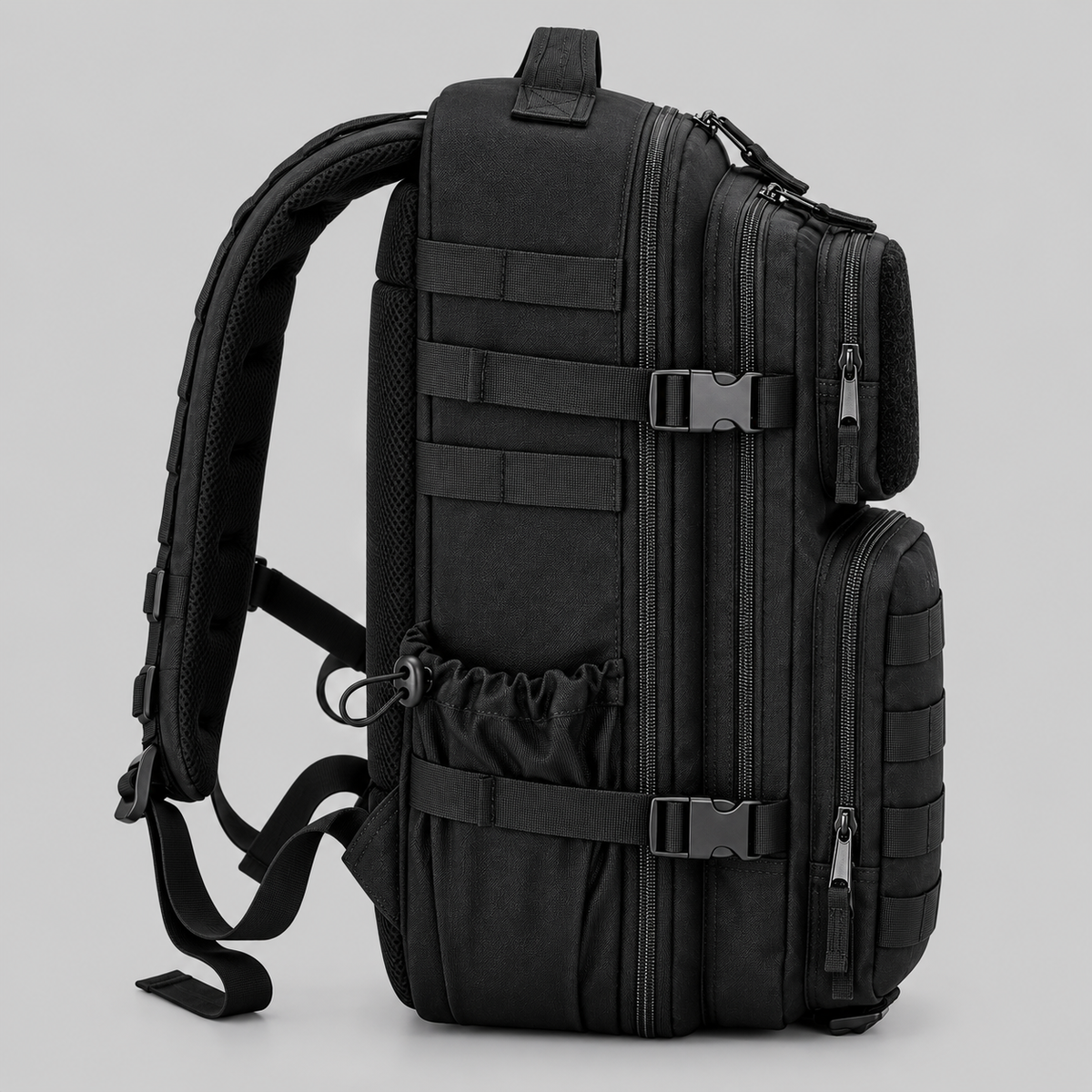 Side profile of Hybryd black 35L tactical gym backpack showing compression straps and MOLLE webbing