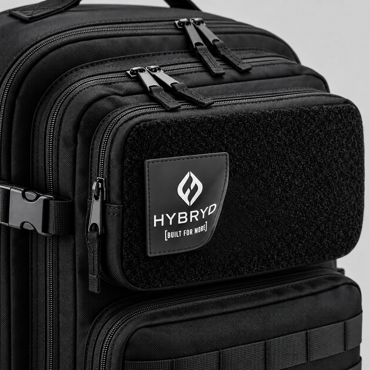 Close-up view of Hybryd logo rubber patch on black 35L tactical fitness bag