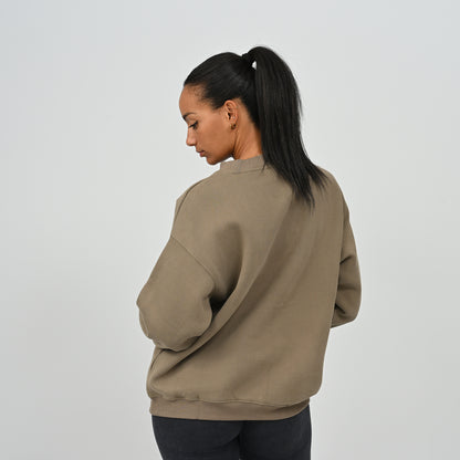 Rear angle view of female model wearing the Women's Hybryd Jasper crew neck sweatshirt in khaki green.