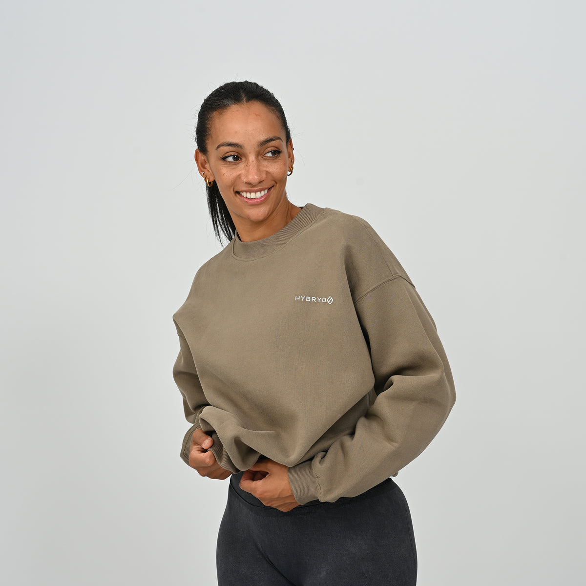 Front view of female model in the khaki Hybryd Jasper relaxed fit crew neck sweatshirt.