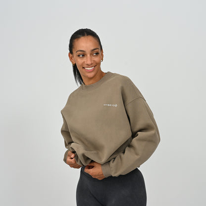 Front view of female model in the khaki Hybryd Jasper relaxed fit crew neck sweatshirt.