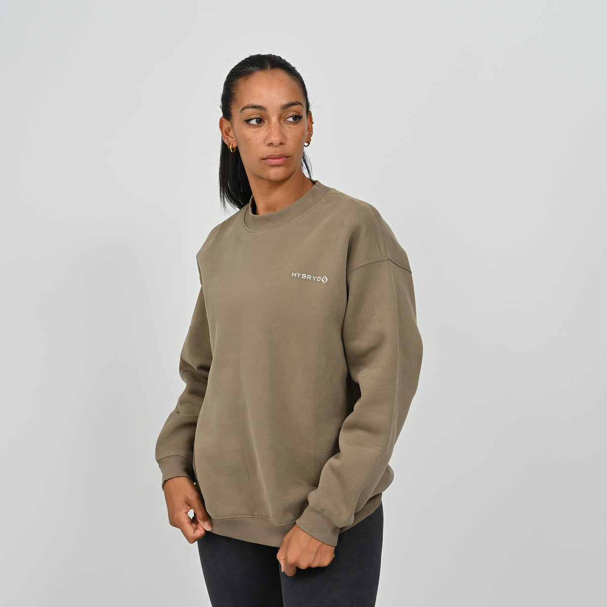 Full front standing view of female model wearing the khaki Women's Jasper fleece crew neck sweatshirt.