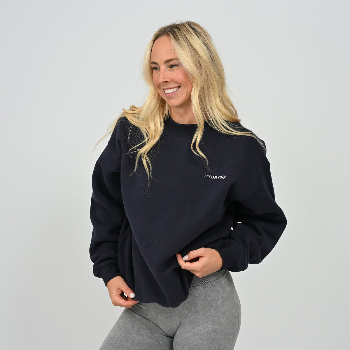 Full front standing shot of female model in the Women's Jasper relaxed fit crew neck sweatshirt in navy blue