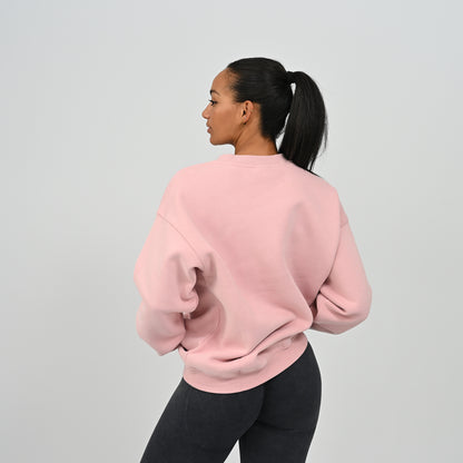 Back three-quarter angle of female model wearing the Women's Jasper crew neck sweater in pink.