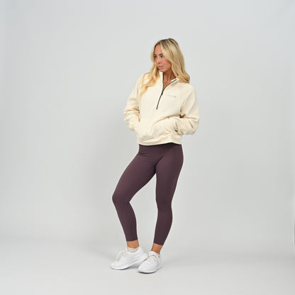Full body front shot of model wearing the cream Hybryd Monterey high collar half zip sweatshirt   
