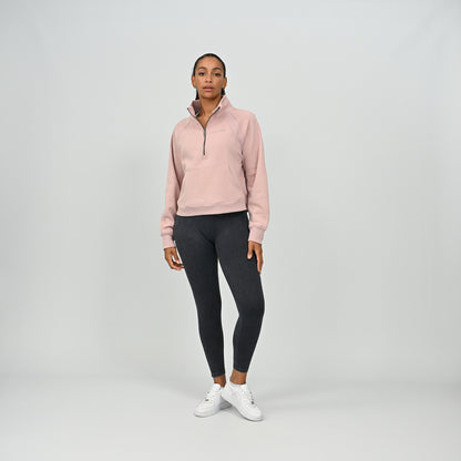 Full body front view of model wearing the dusty pink Hybryd Monterey half zip sweatshirt with kangaroo pocket