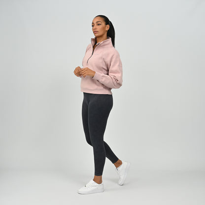 Three-quarter full body view of model wearing the dusty pink Hybryd Monterey half zip sweatshirt