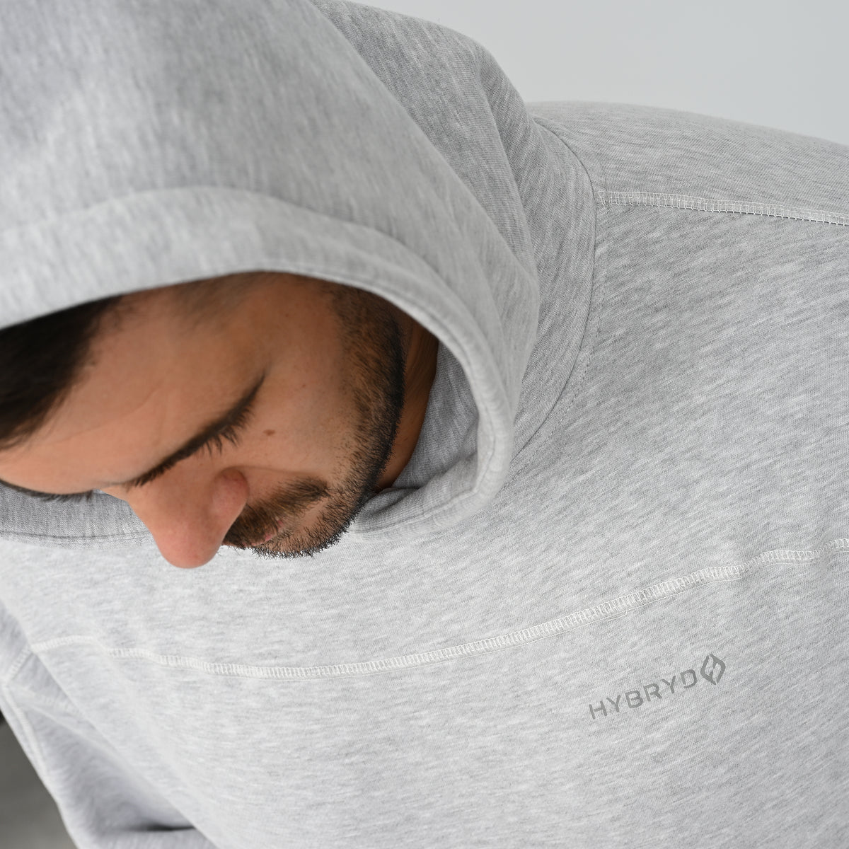 Close-up view of male model wearing the grey Hybryd Palmer fleece lined hoodie with hood up   
