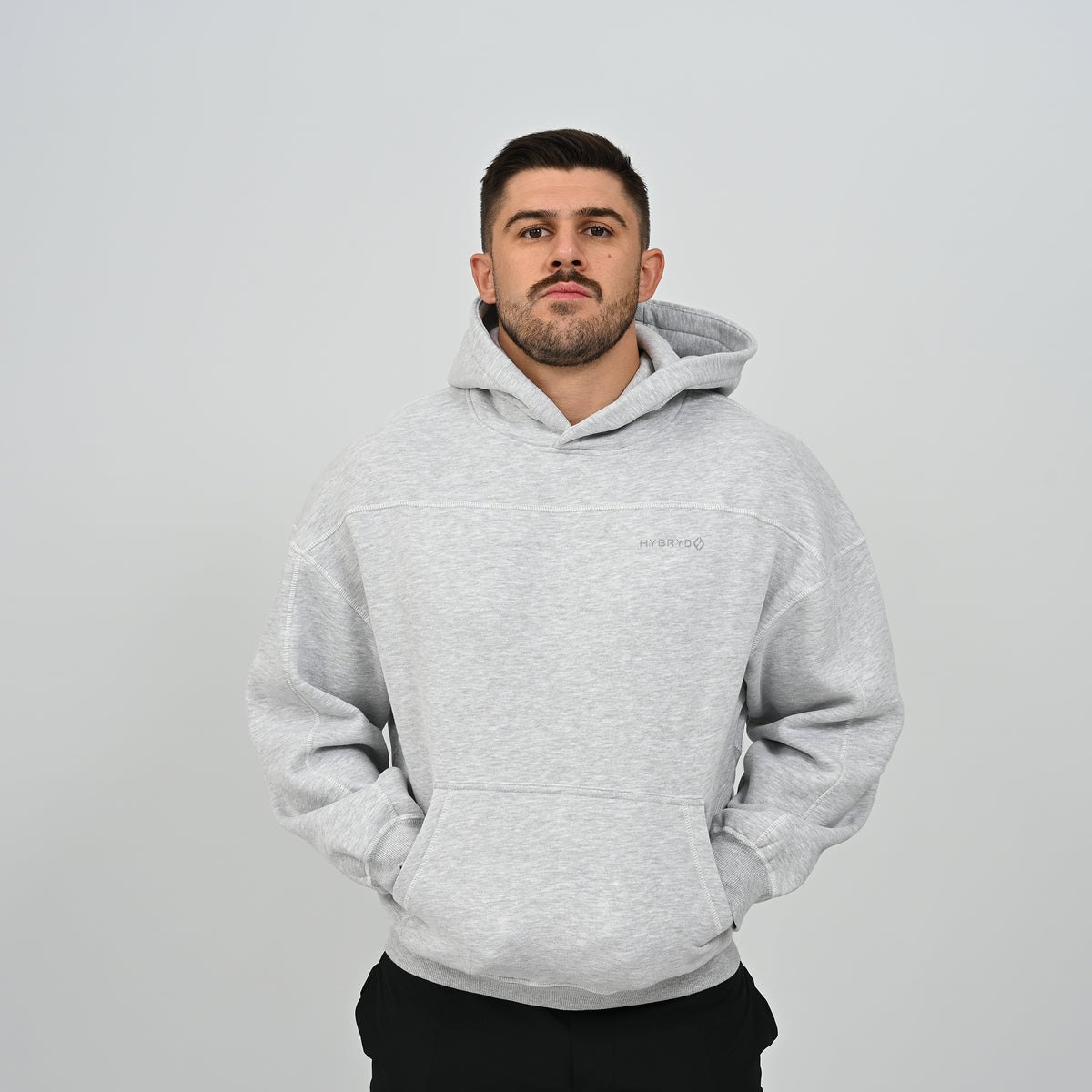 Full front view of male model standing in the grey Hybryd Palmer fleece lined hoodie   
