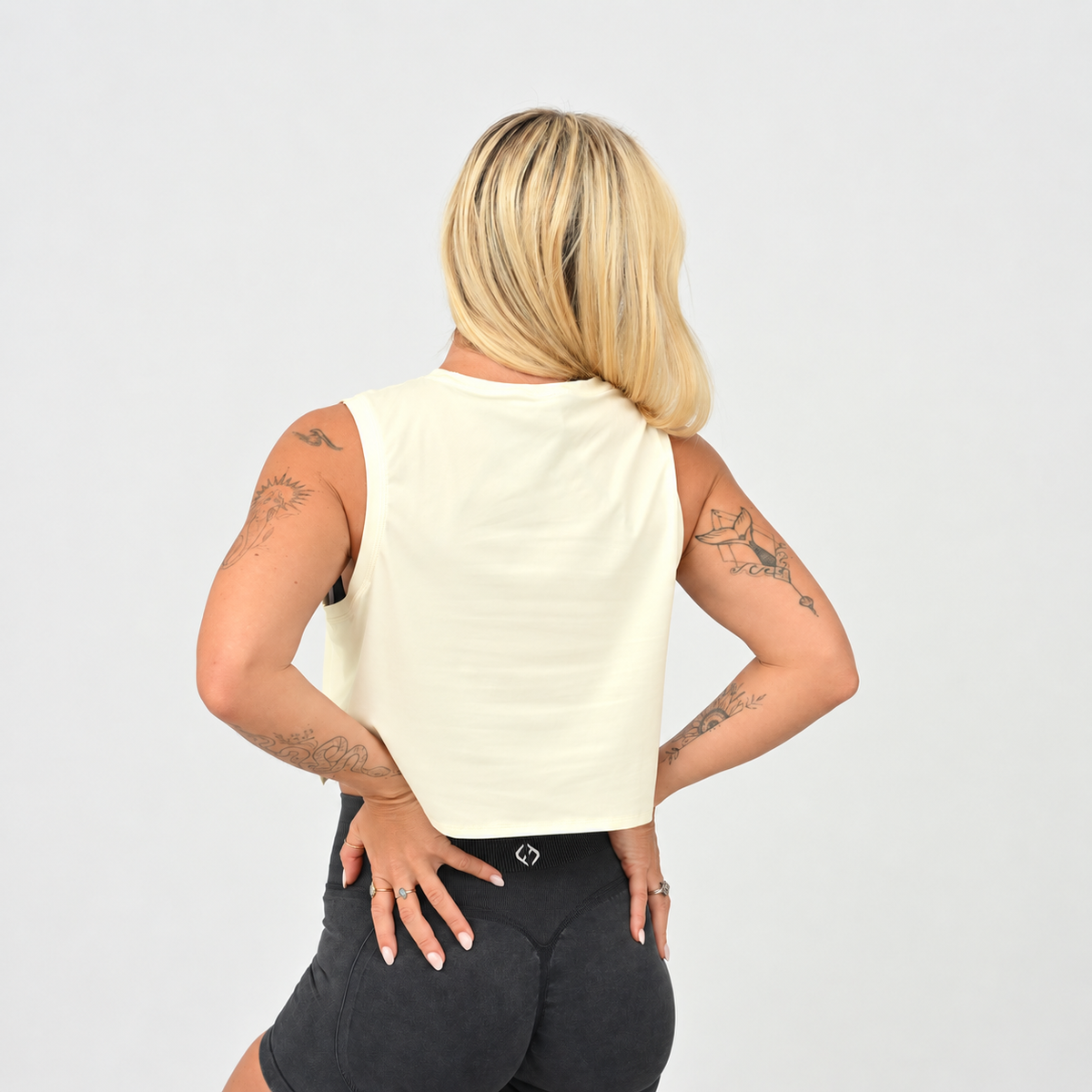 Back view of the women’s Butter Ivy Crop Vest showing the wide-cut armholes and clean cropped shape