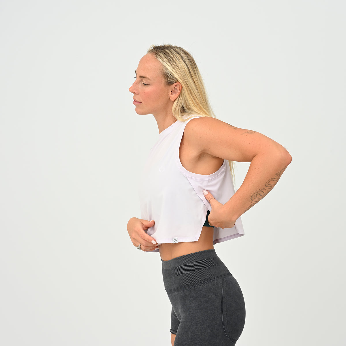 Side view of the women’s Ivy Crop Vest in lilac, showing the wide-cut armholes and cropped fit.
